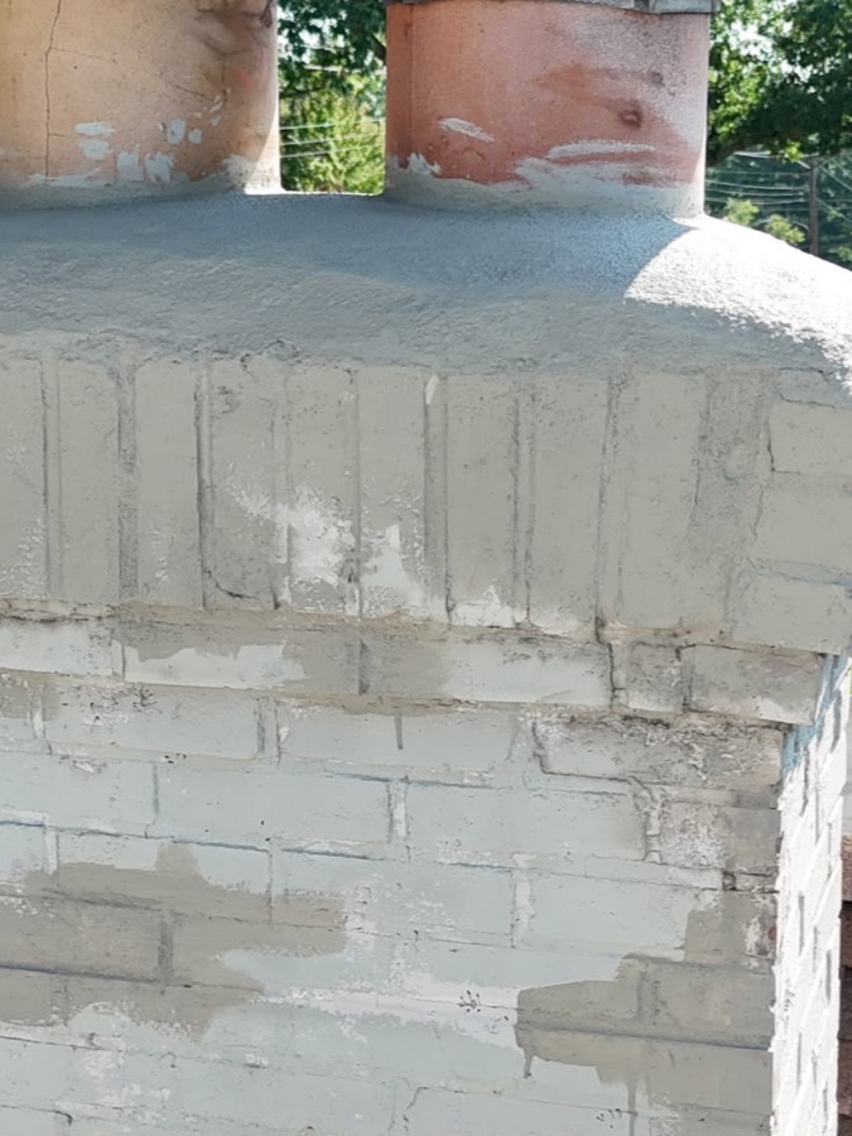 The other side of the chimney top, with the old crown sloping to the edge and no drip edge