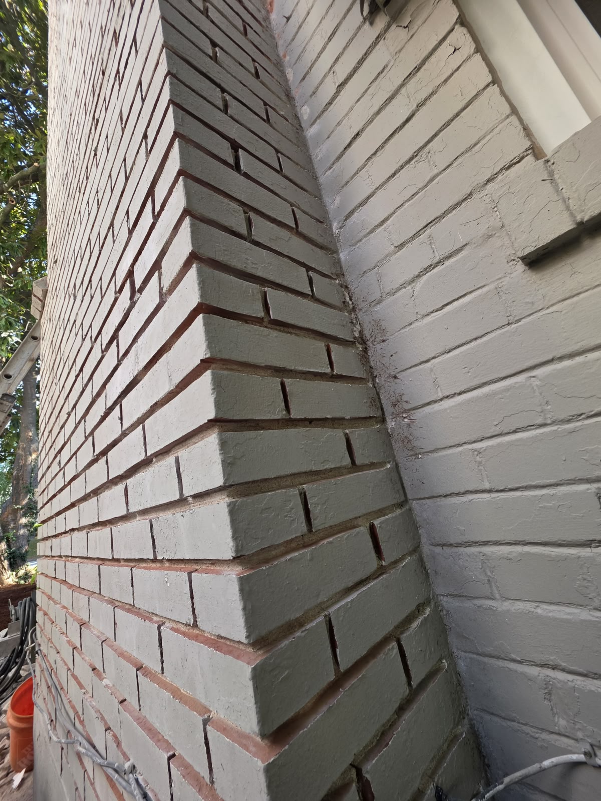 Chimney corner with all of the old mortar cut out of the joints