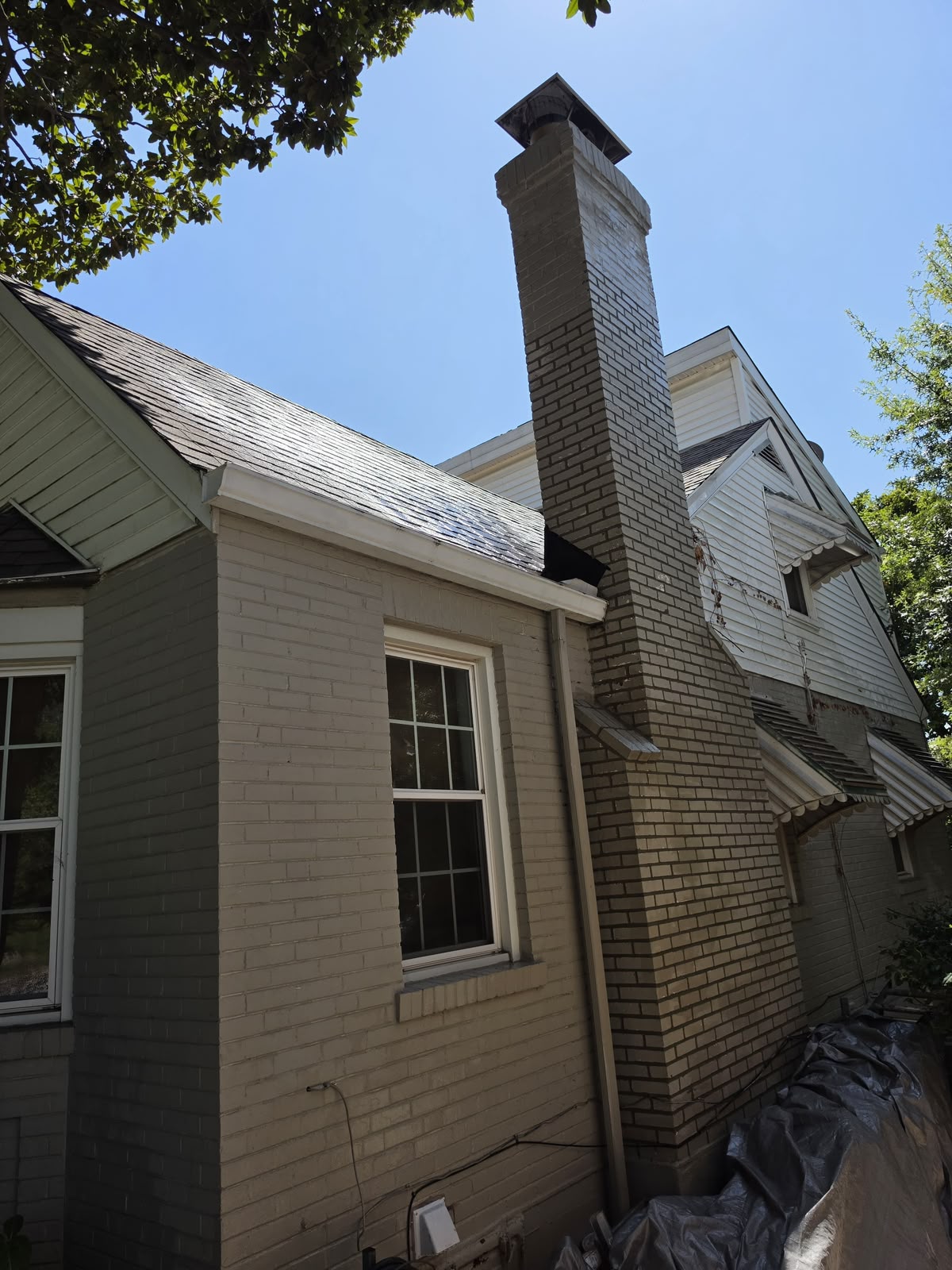 Chimney tuckpointed with fresh mortar up to the height that could be reached, with the upper section still to do